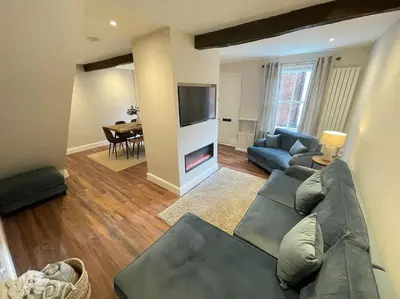 a living room with a couch and a fire place at Georgian 3 bed house in historic town centre in Shrewsbury