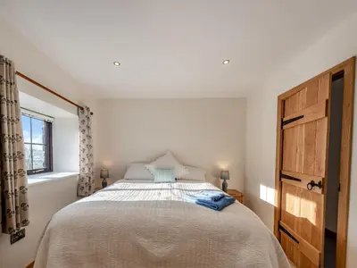 a bedroom with a bed and a window at Parlwr Godro - Uk41513 in Llanfair Clydogau