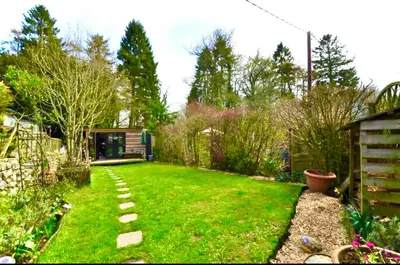 a garden with green grass and a pathway at Dove Cottage in Newbridge on Wye