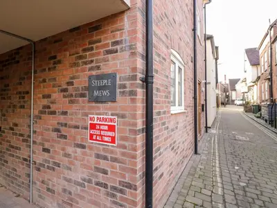 a brick building with a no parking sign on it at The Stokesay in Ludlow