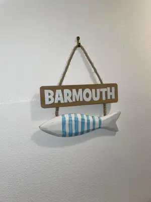 a sign with a knife hanging on a wall at Flat 2, Ty Newydd in Barmouth