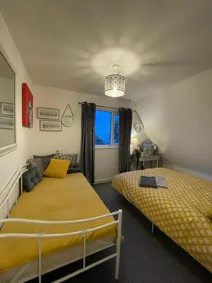 a bedroom with two beds and a window at Holiday home, Tywyn, great location in Tywyn