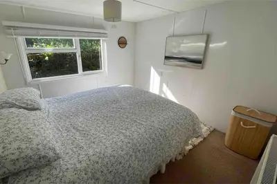 a bedroom with a bed and a window at Valley View Lodge in Welshpool