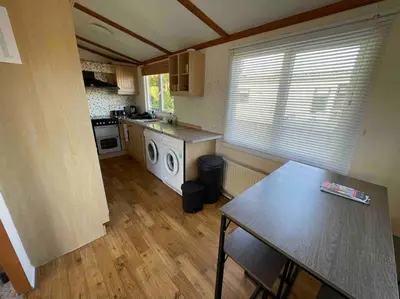 a kitchen with a table and a counter top at Valley View Lodge in Welshpool