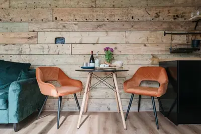 a living room with a table and two chairs at Dyffryn Ceri in Penuwch