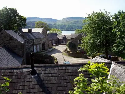 a group of houses with a view of a lake at Y Swdio, Ferm Glandwr in Barmouth