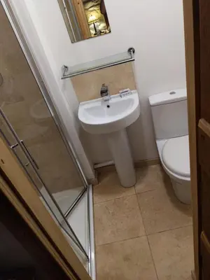 a bathroom with a sink and a toilet at Y Swdio, Ferm Glandwr in Barmouth