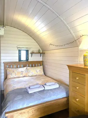 a bedroom with a bed with two towels on it at Mountain View Pod in Rhayader