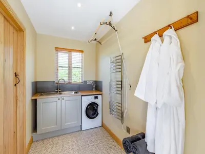 a laundry room with a washing machine and a sink at The Mill in Llandegley