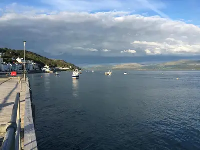 a group of boats in a large body of water at Beautiful Aberdovey Seafront Apartment 2 in Aberdyfi