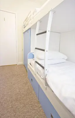 a bunk bed room with a white bunk bed at Lovely seafront 2 bedroom Apartment 4 in Aberdyfi