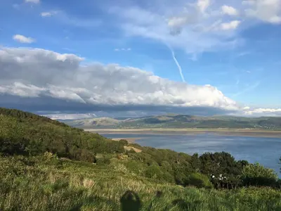 a view of a lake in the middle of a hill at Lovely seafront 2 bedroom Apartment 4 in Aberdyfi