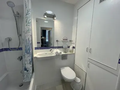 a white bathroom with a toilet and a sink at Lovely seafront 2 bedroom Apartment 4 in Aberdyfi