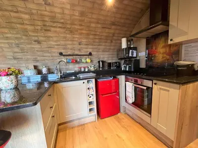 a kitchen with a red refrigerator and a sink at Rabbit Warren in Llansantffraid-ym-Mechain