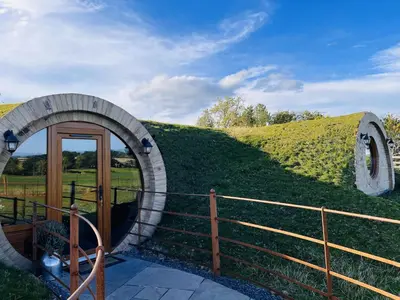 a circular building with a tunnel in the grass at Rabbit Warren in Llansantffraid-ym-Mechain