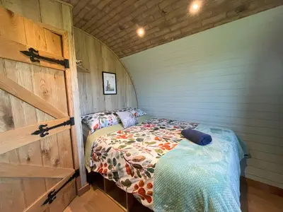 a small bedroom with a bed in a room at Rabbit Warren in Llansantffraid-ym-Mechain