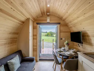 a small living room with a table and a tv at Beech Uk36260 in Llanfair Caereinion