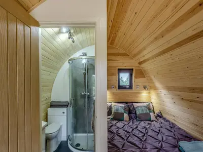 a bedroom with a shower and a bed in a room at Beech Uk36260 in Llanfair Caereinion