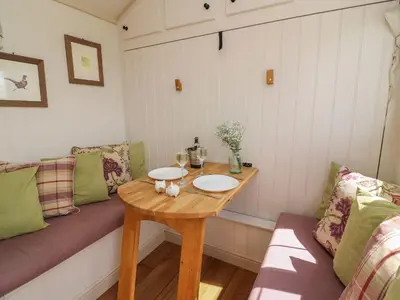 a small room with a table and a couch at Shepherds View in Rhayader