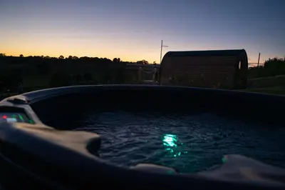 a hot tub with a green light in the water at Celyn in Welshpool