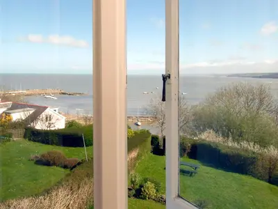 a view of the ocean from a window at Seafield in New Quay