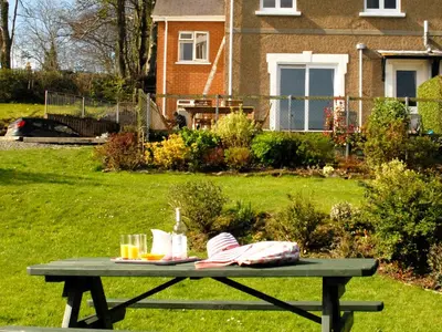 a picnic table with food and drinks on it in a yard at Seafield in New Quay