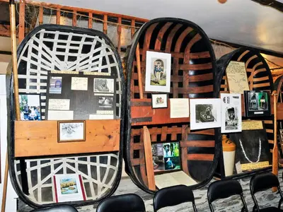 a room with a bunch of pictures on a wall at Cerniw - Cottage in Aberaeron