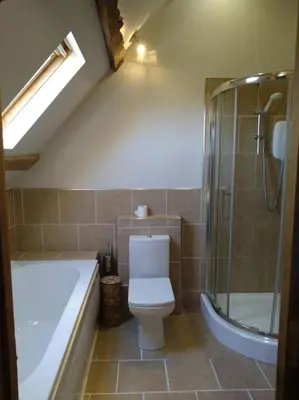 a bathroom with a toilet and a shower and a tub at Wern Ddu, Defynnog - Brecon Beacons in Brecon