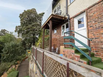 a brick house with a staircase on the side of it at Westoe Hideaway in Llangollen