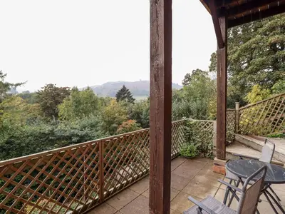 a patio with a table and chairs on a porch at Westoe Hideaway in Llangollen