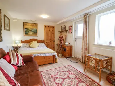 a bedroom with a bed and a couch at Westoe Hideaway in Llangollen