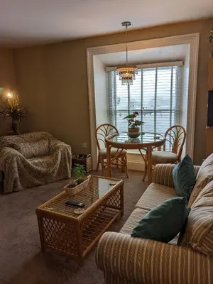 a living room with a couch and a table at Pier View Sea View Apartment Aberystwyth Promenade in Aberystwyth