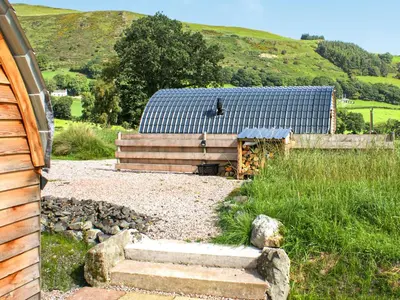 a building with a staircase next to a house at Creyr Glas Pod -Uk41796 in Hirnant