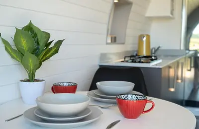 a table with four cups and saucers on it at Derwen in Welshpool
