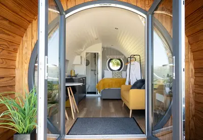 an arched entryway to a tiny house with a living room at Derwen in Welshpool