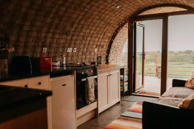 a kitchen with a counter and a stove top oven at Owl Hollow in Llansantffraid-ym-Mechain
