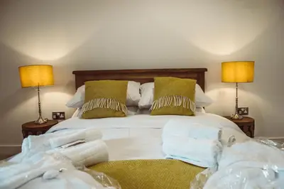 a bedroom with a bed with two lamps at Swallows Rest in Montgomery
