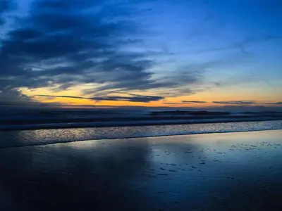 a view of a beach with a cloudy sky at Ty'n y Clawdd in Dyffryn