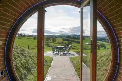 anorthole entrance to a building with a table and chairs at Foxes View in Rhayader
