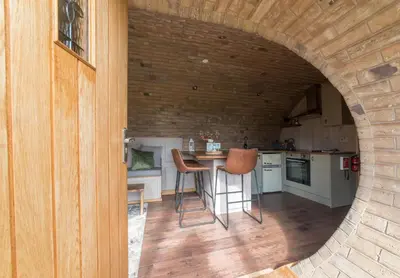 a kitchen with a table and chairs in a room at Hare's View in Rhayader