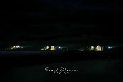 a view of a city at night with lights at Badgers View in Rhayader