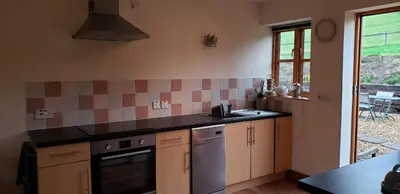 a kitchen with a sink and a counter top at Seven Stars- hot tub & garden with fabulous views. in Llandrindod Wells