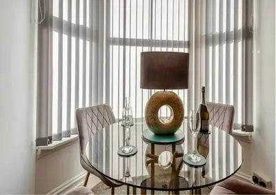a dining room with a glass table and two chairs at Jack's House in Tywyn