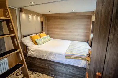 a small bedroom with a bed in a room at Hillside Lodge in Nantmel