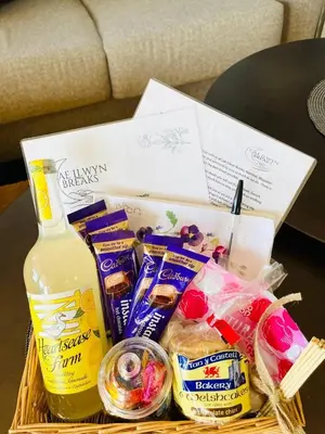 a basket filled with food and a bottle of milk at Oak Tree View in Nantmel