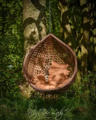 a baby in a basket hanging from a tree at Panteg in Llanrhaeadr-ym-Mochnant