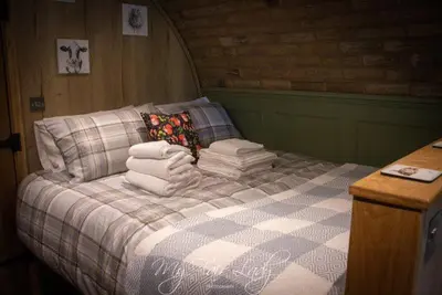 a bed with a pile of towels on it at Panteg in Llanrhaeadr-ym-Mochnant