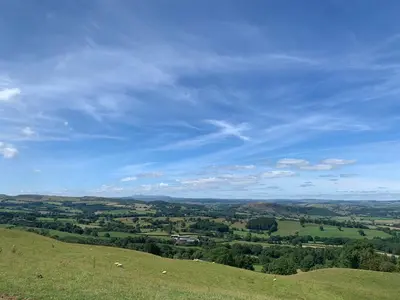 a view of a green field with a blue sky at Mountain View in Llanfair Caereinion