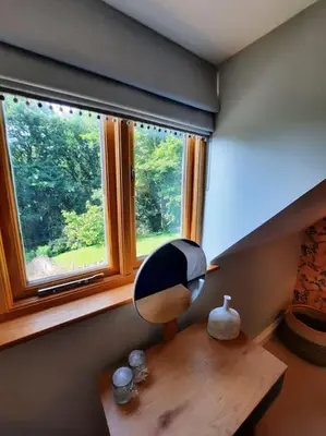 a room with a desk with a mirror and a window at The Hen Den in Ludlow