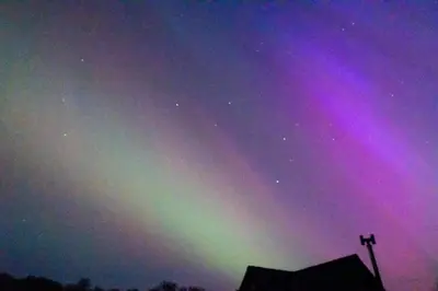 an aurora in the sky over a building at Y Cwtch - Panoramic mountain views within Snowdonia's National Park - 4x4 only in Dolgellau